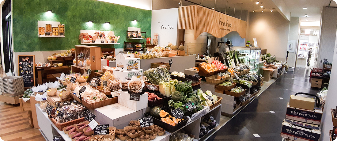旬の野菜や果物が並ぶ、木の温もりを感じる店内